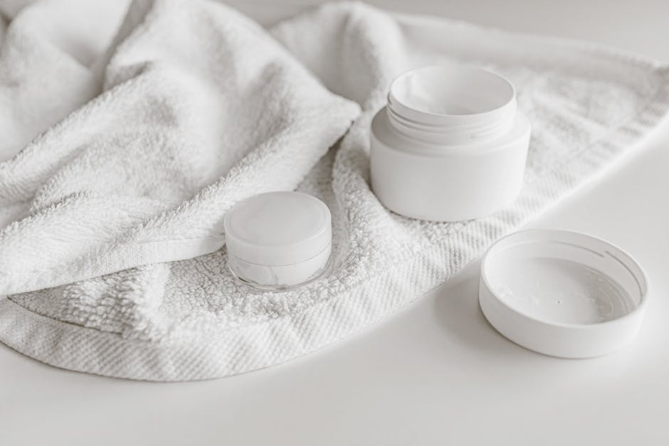 Clean and minimalist presentation of skincare products with a towel.