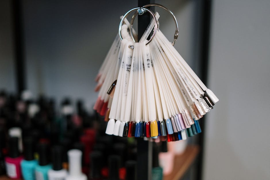 A vibrant display of nail polish swatches hanging in a beauty salon, showcasing diverse color options for manicure trends.
