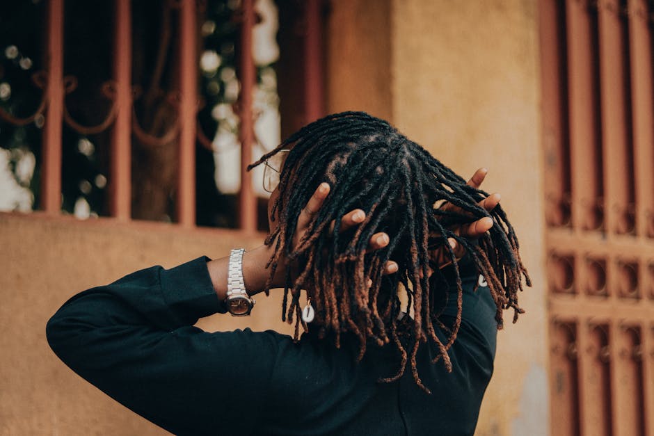Person with dreadlocks styled in a fashionable manner, captures modern urban vibe.